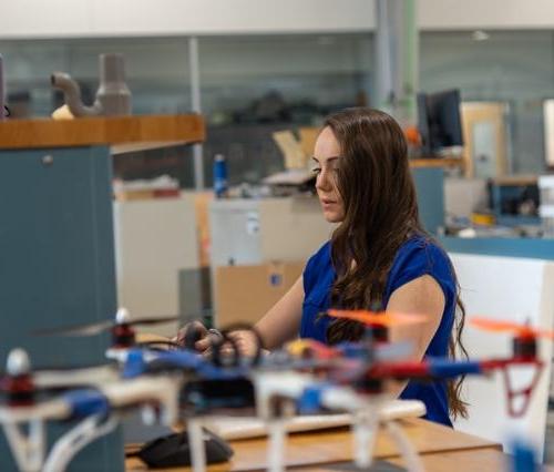 An aeronautics engineering student working on a computer in the student design center