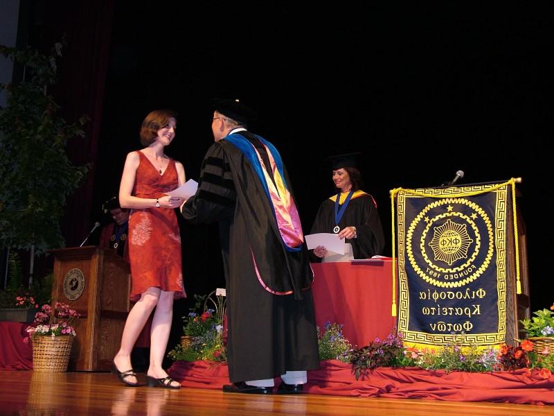 A student receiving her induction certificate