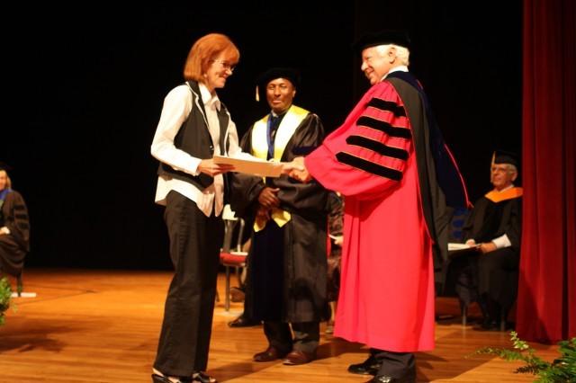 Receiving a handshake after getting her certificate